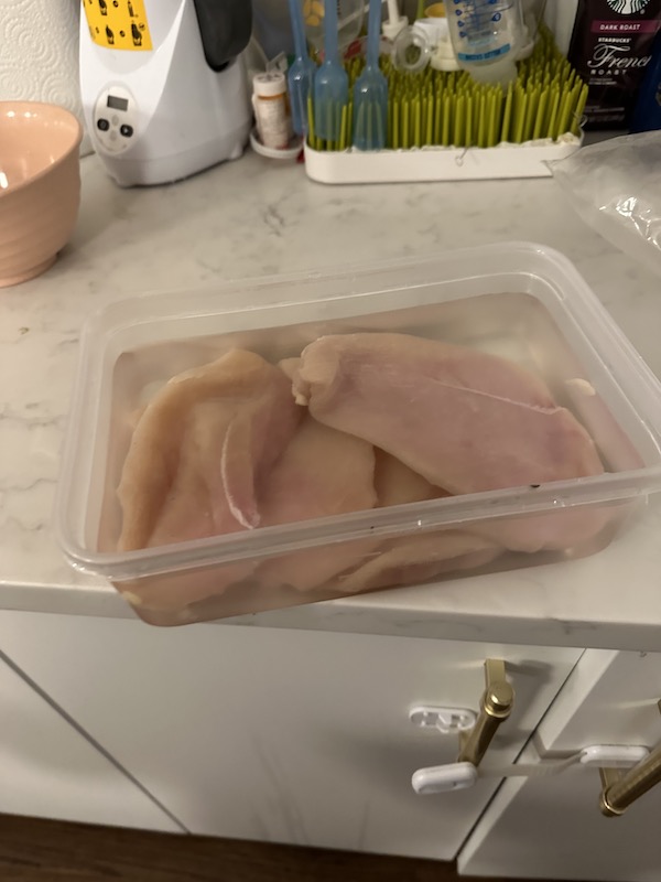 chicken breasts in the warm salt water