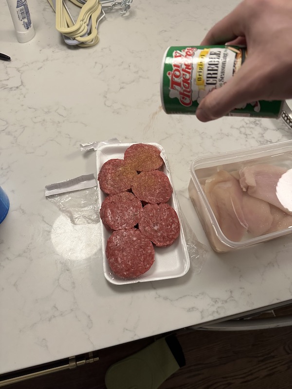 putting dry rub on burger patties